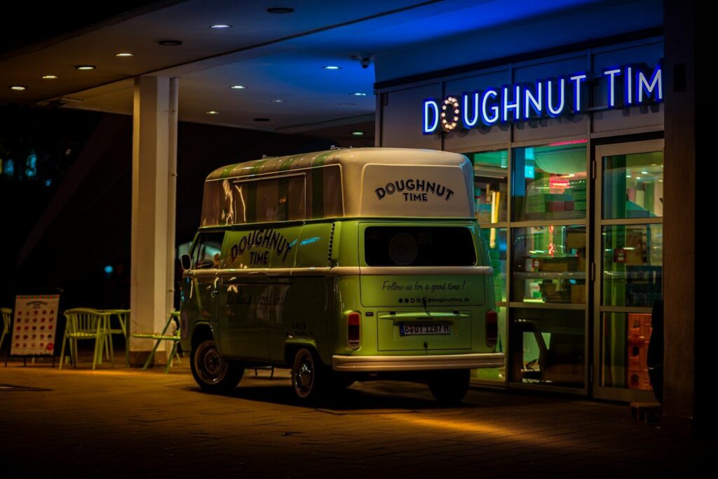 A bus parked in front of a building at night